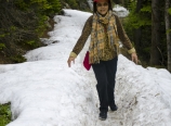 Mom hiking up snow-covered Lake Agnes Trail
