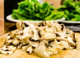 Sliced mushrooms and spinach leaves